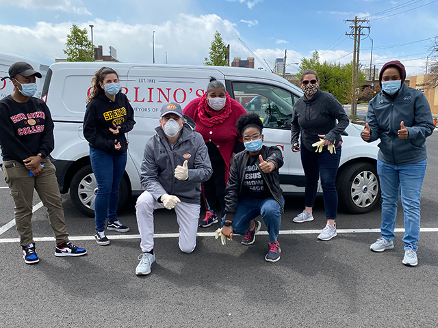 Team members excitedly next to Carlino's Meal Van.